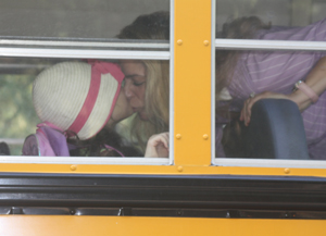 Mom kisses child on bus