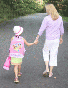 Mom walks child to bus stop