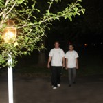 Teens walking toward lamplight