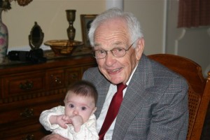 Elderly man holding baby