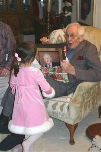 Child gives photo gift to elderly man