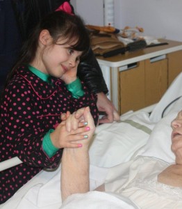 5 year old granddaughter lovingly looks at grandmother