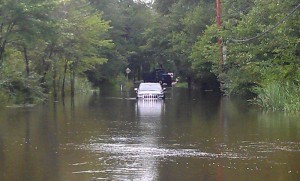 Hurricane Irene  flooded road  car in flood