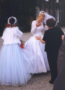 Seamstress helping bride, seamstress and bridesmaid helping bride