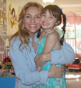 Mom and daughter snuggle, mom and daughter laughing and being silly in the playroom, super hugs