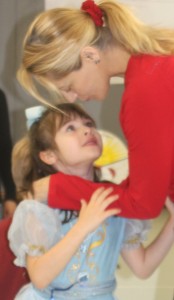 Little girl looks up to mother, mother kisses daughter, comforting, love, mom and daughter, toddler in Cinderella dress