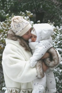 Snowy love, snuggling in the snow, mom and baby on 1st sled ride, puffy white snowsuit for baby, cuddles and kisses in winter, snowy kisses and hugs