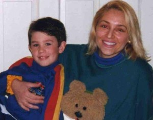 Mom & son, mom snuggling son in teddy shirt, mom loves cares and nurtures son, mom communicates with son, son and mom happy