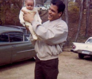 Daddy raising baby Bianca up, 1960's baby and Dad, old cars