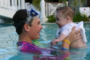 Superhero and Little Petal, Big Brother, little sister, Caribbean, giggles in the pool, lifting up little sister