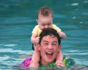 Superhero and Little Petal, Big Brother, little sister, Caribbean, pool, swimming pool, baby playing with big brother in the pool