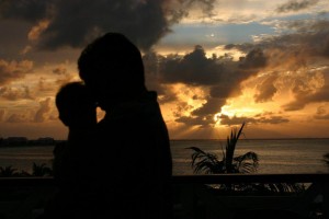 Superhero and Little Petal, Big Brother, little sister, snuggles in the Caribbean, heart in the sunset